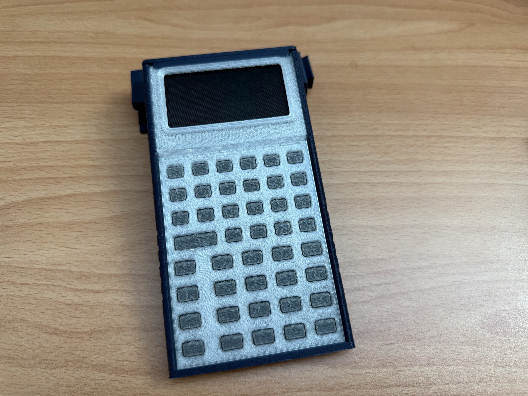 A second physical prototype view shows the calculator seated in the printed shelf stand.